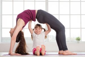 mom and daughter doing yoga